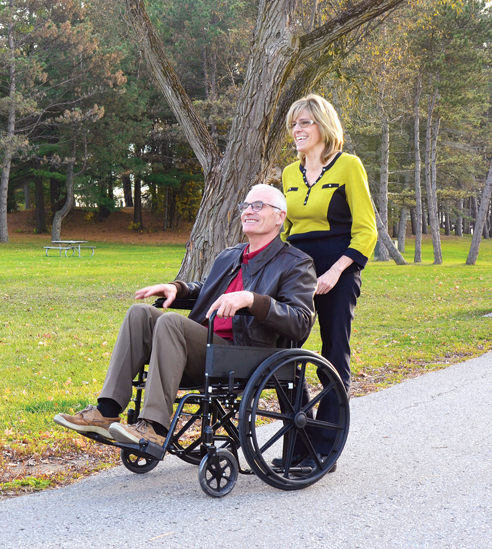 Woman pushing man in 56084 Wheelchair